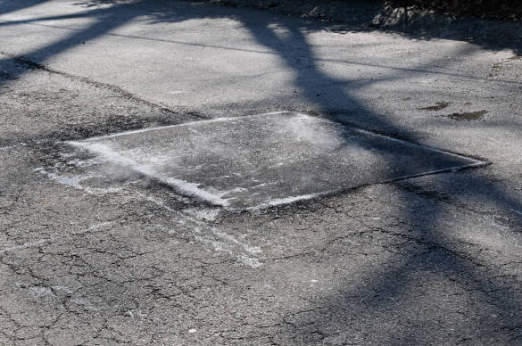 a completed asphalt pothole repair