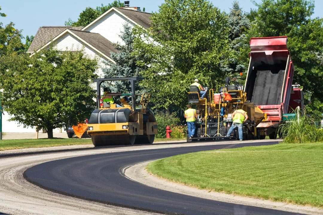 Laying new pavement in a residential neighborhood Laying new pavement in a residential neighborhood